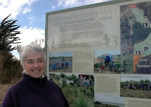 Cathy and interpretation panel at start of Bushy Point walkway Bryson Road